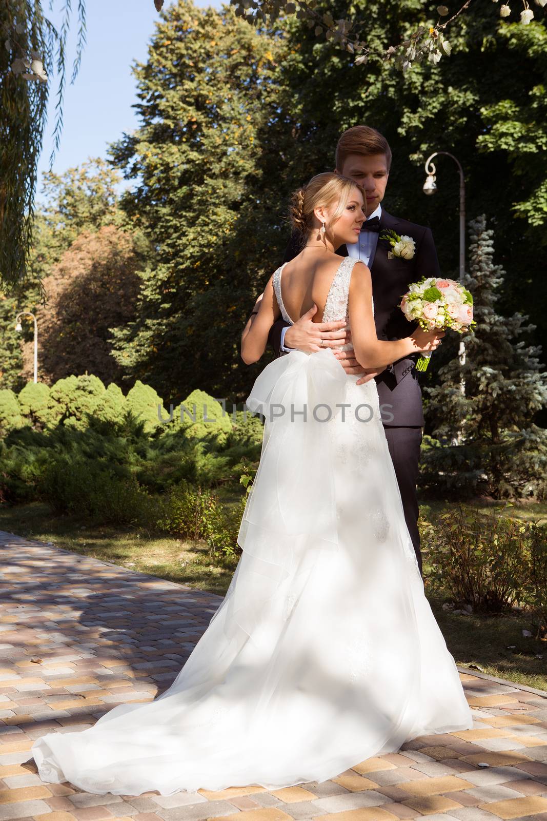 Beautiful wedding couple is enjoying wedding in the sun. 