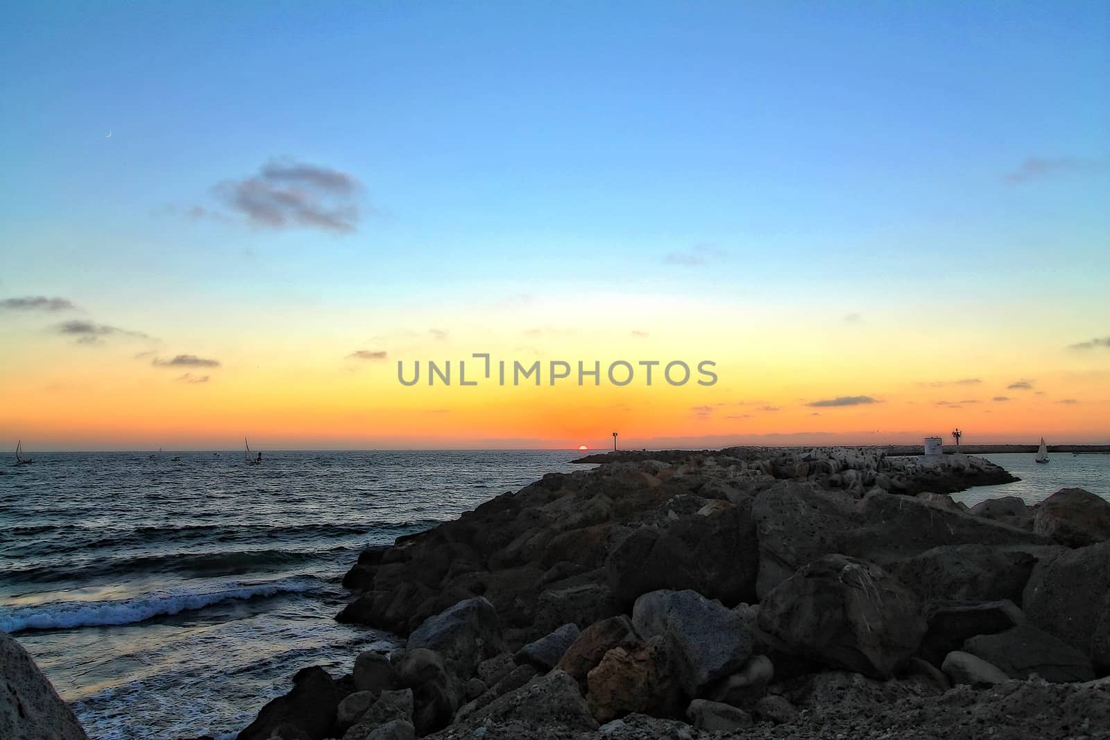 Beach sunset with rocks and sky by Timmi