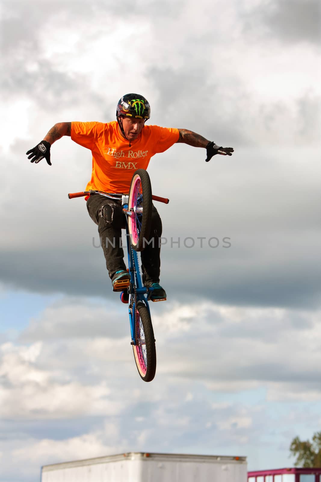 Hampton, GA, USA - September 27, 2014:  A young man with the High Roller BMX club takes his hands off the handlebars while performing a midair BMX stunt at the Georgia State Fair.