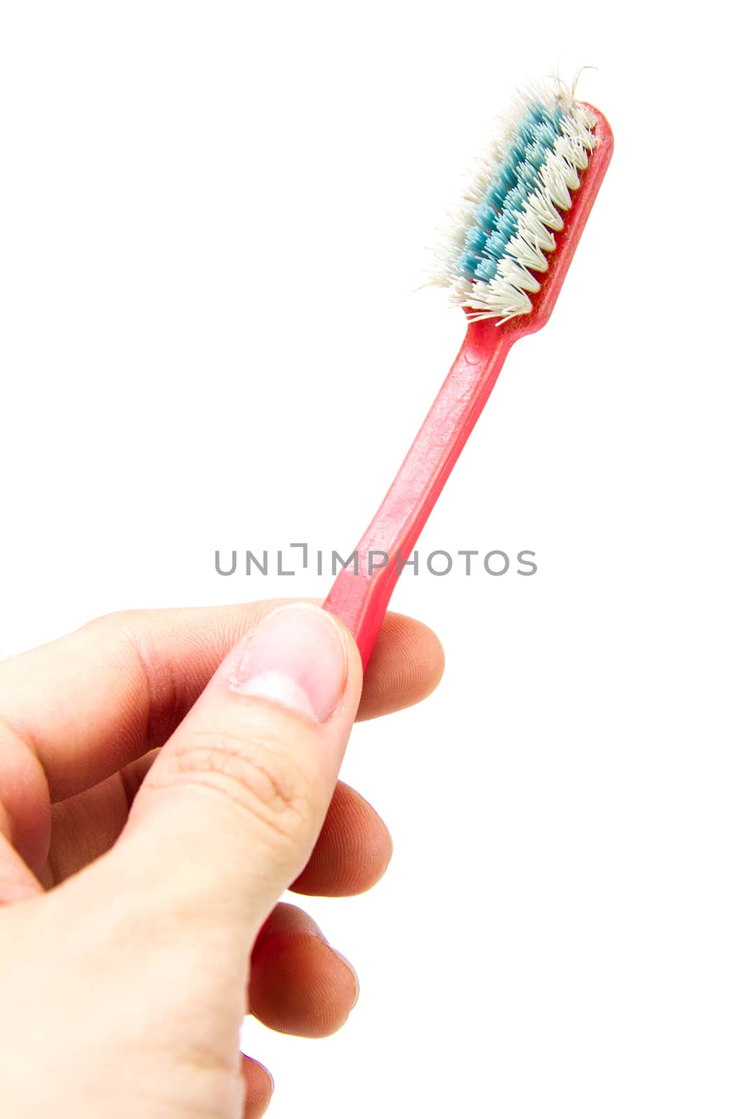 old toothbrush in hand isolated on white background