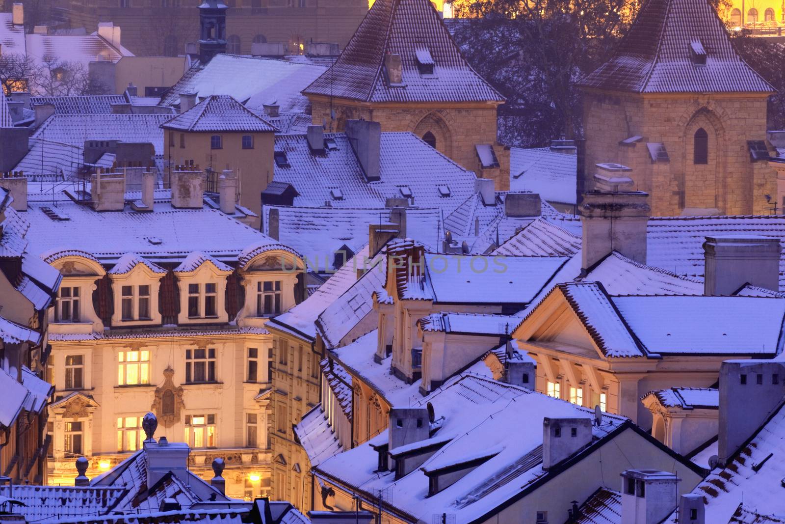 prague - winter view of lesser town rooftops covered with snow