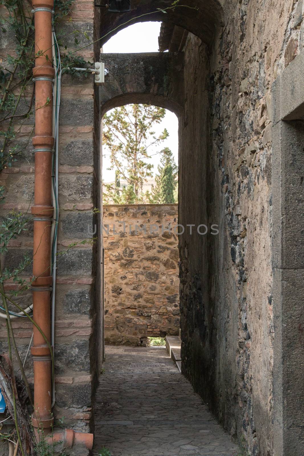Narrow passage in an ancient castle with lava stone