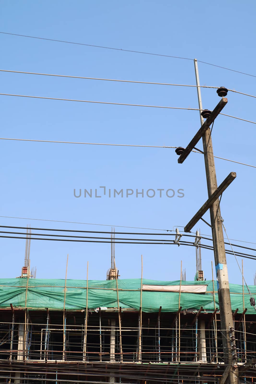 The electricity post and underconstruction building.