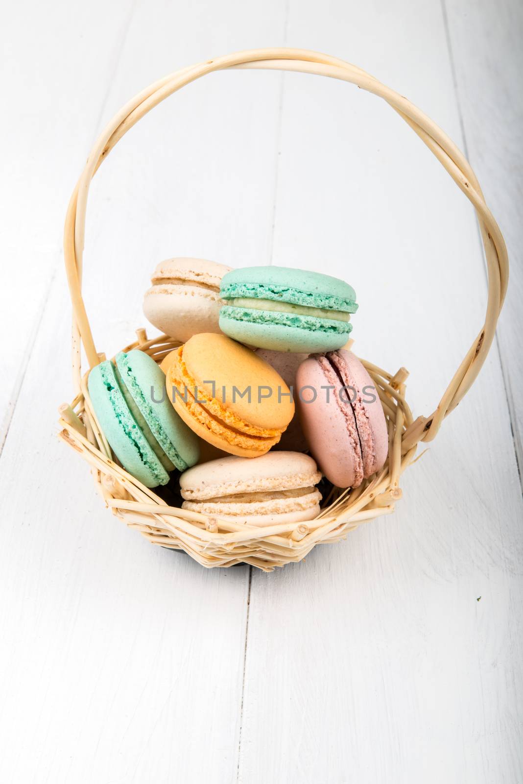 Set of macarons on white wooden table by marius_dragne