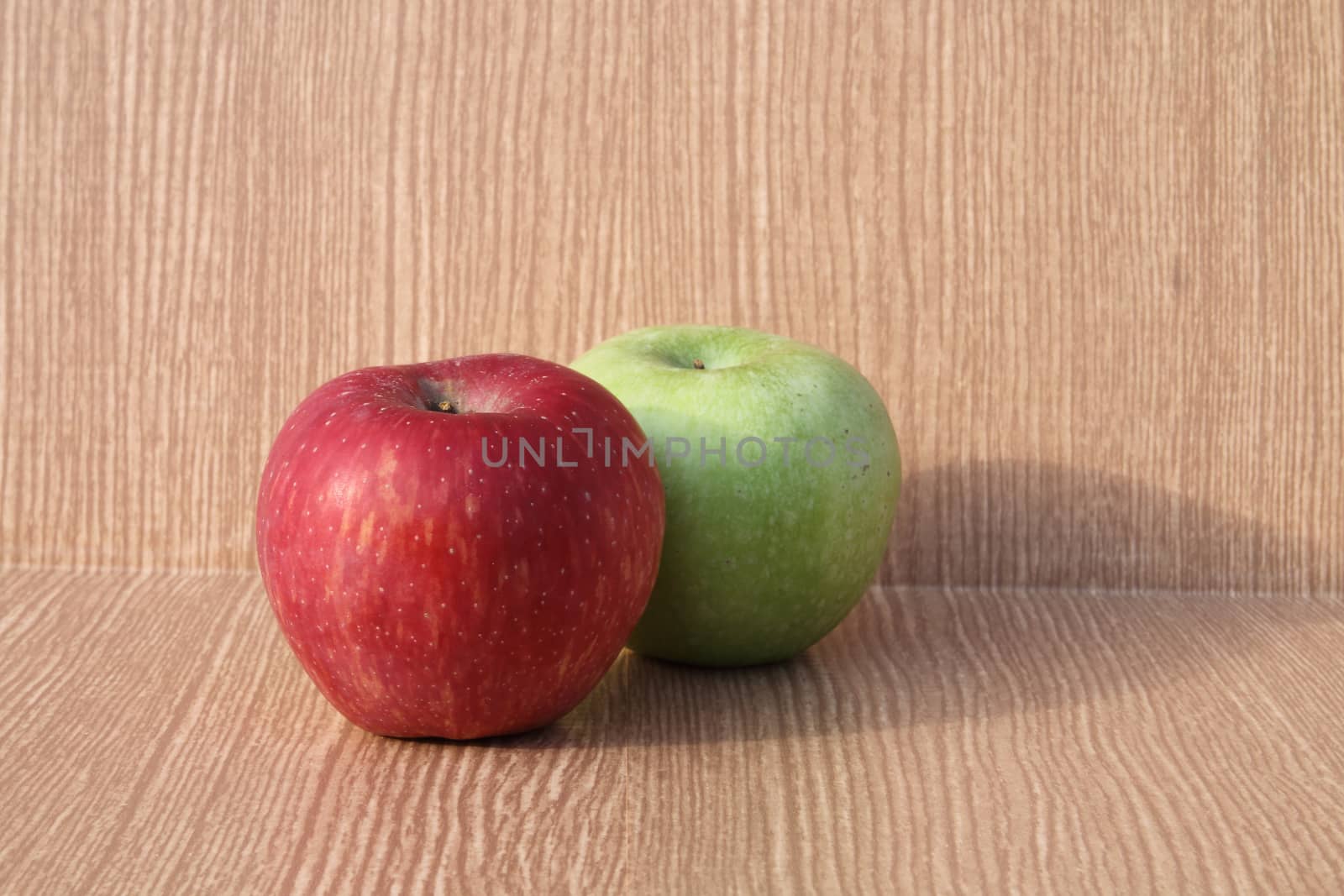red apple and green on wooden background .