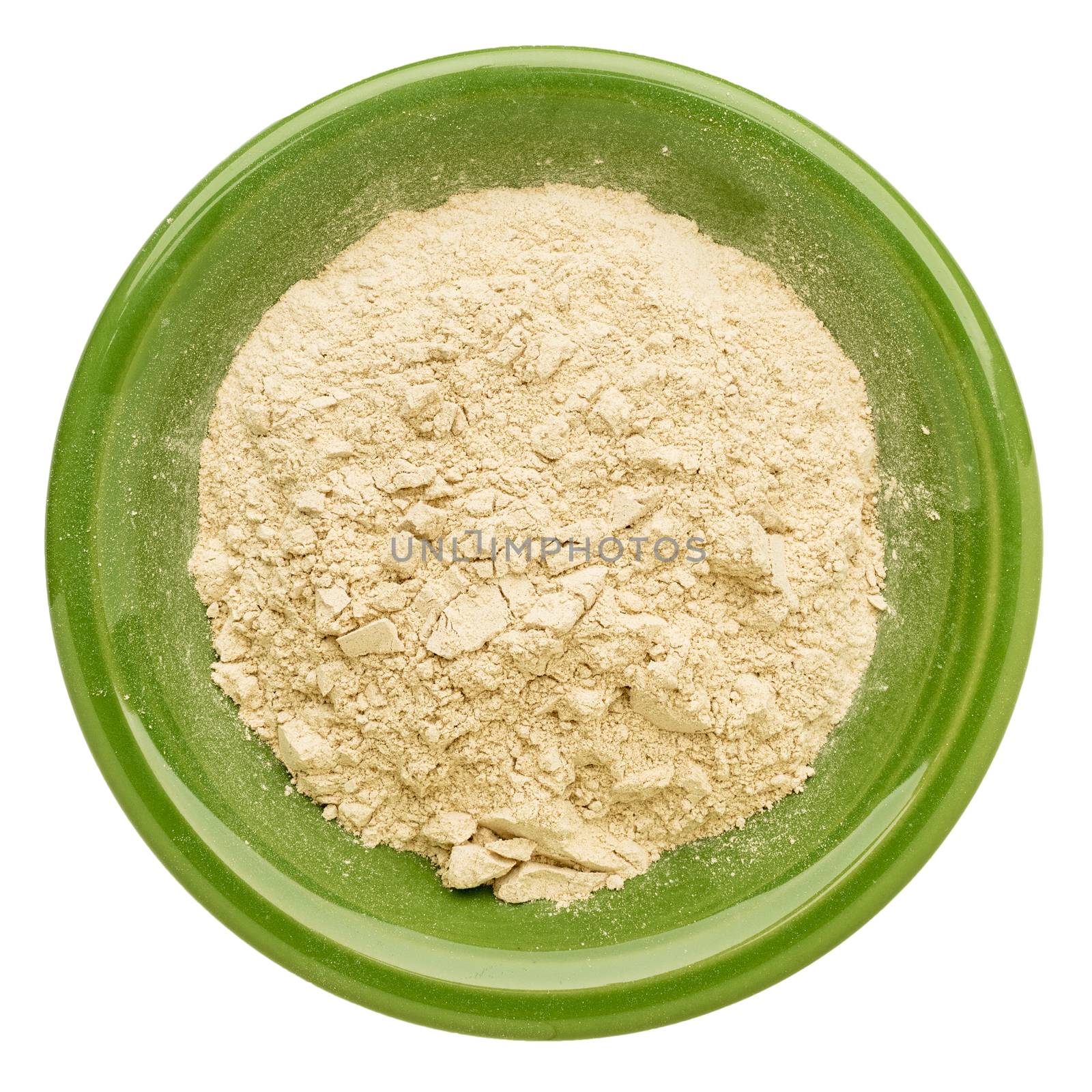 maca root powder in an isolated green ceramic bowl