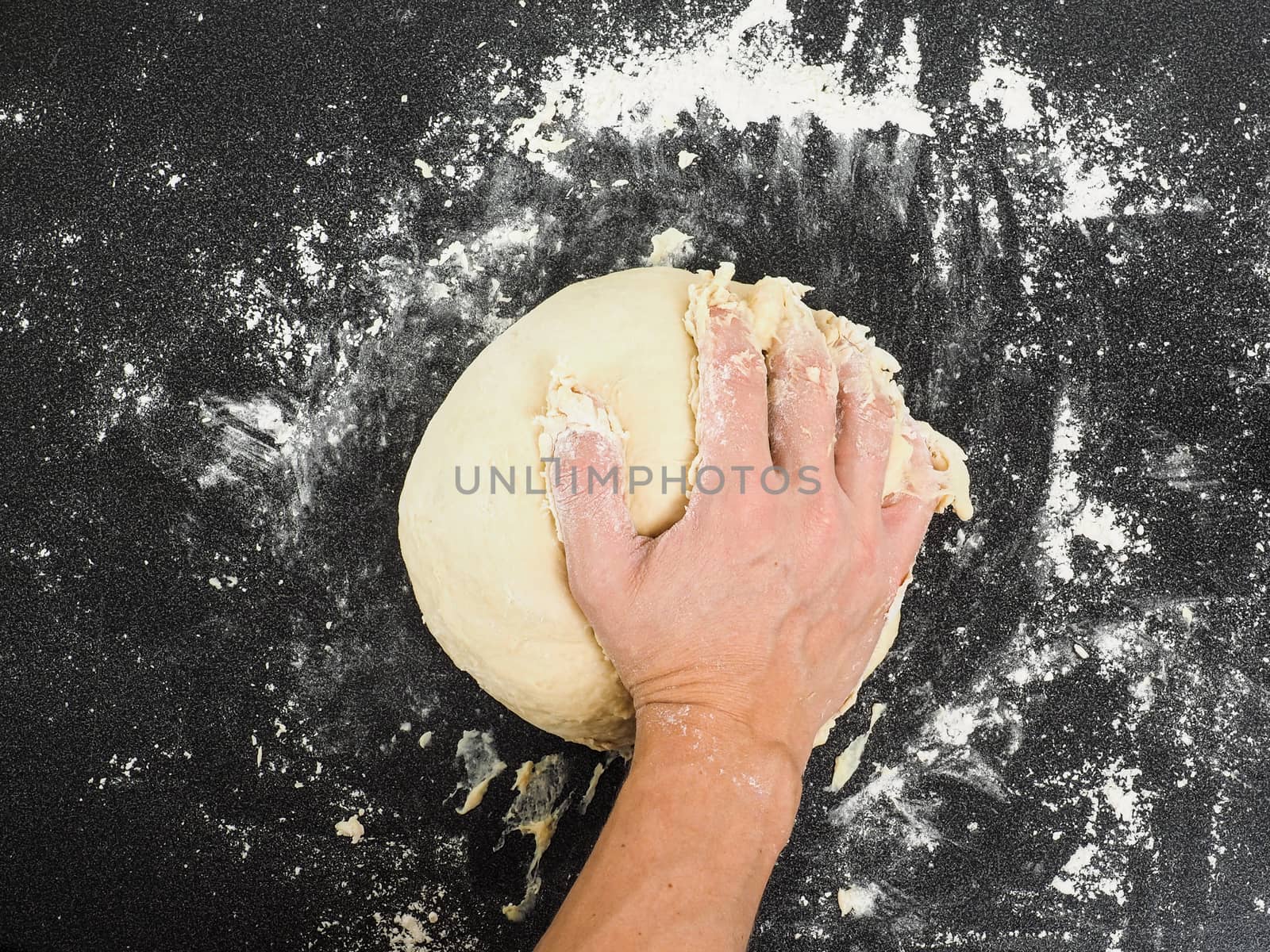Hands kneading dough by Arvebettum