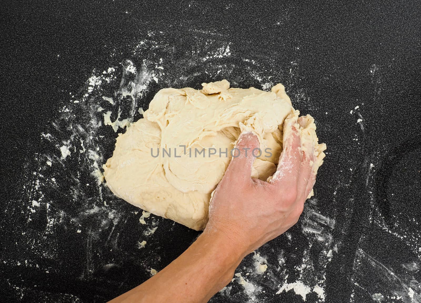 Hands kneading dough by Arvebettum