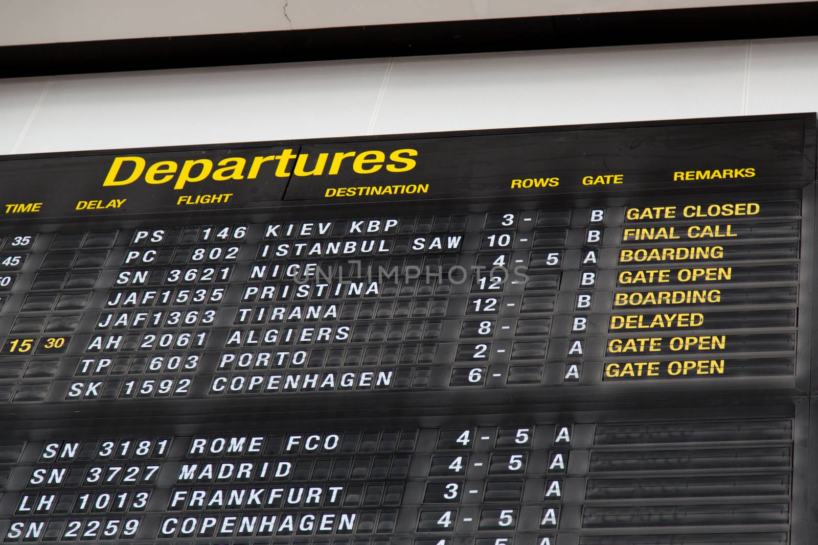 Airport departure board in terminal with flight information