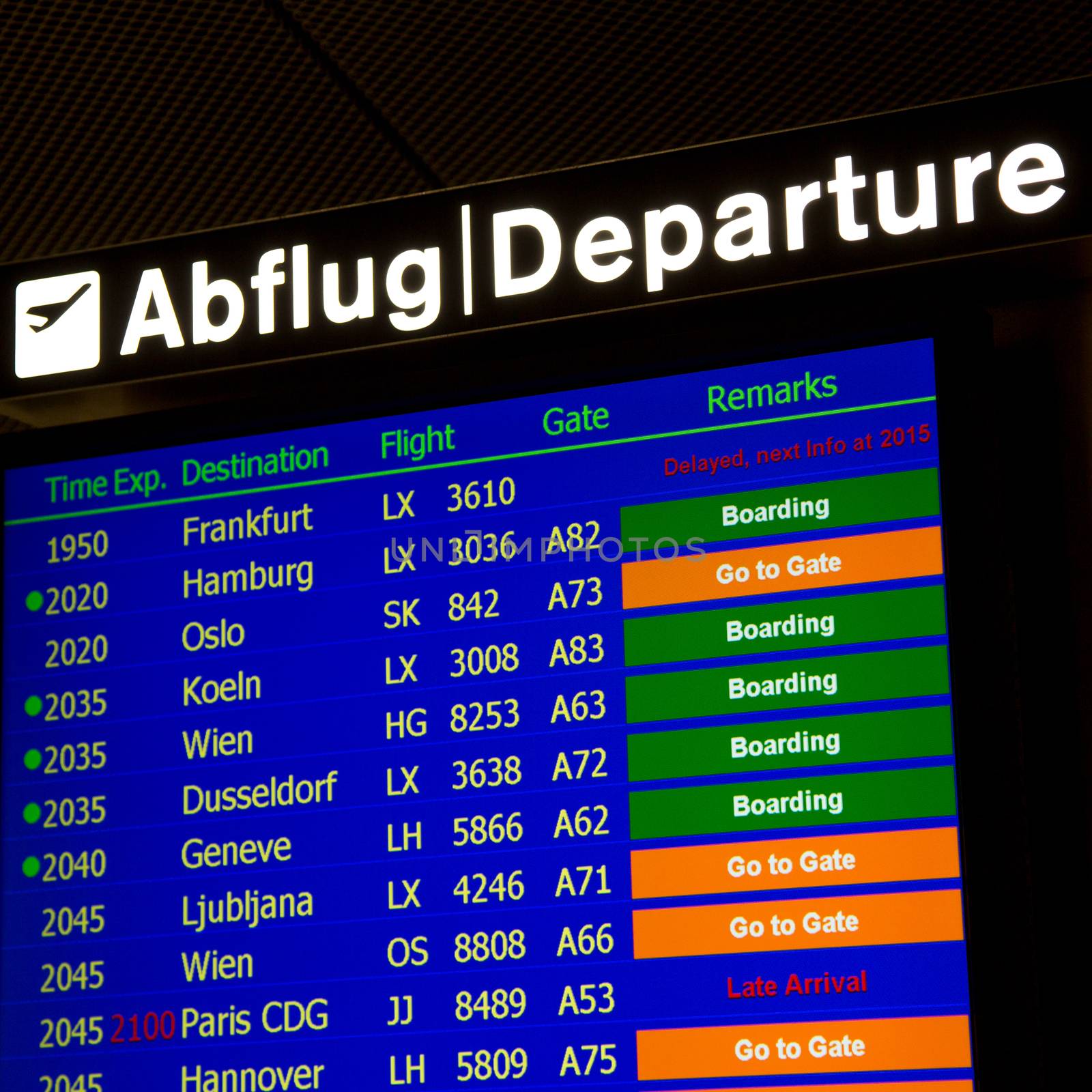 Airport departure board in terminal with flight information