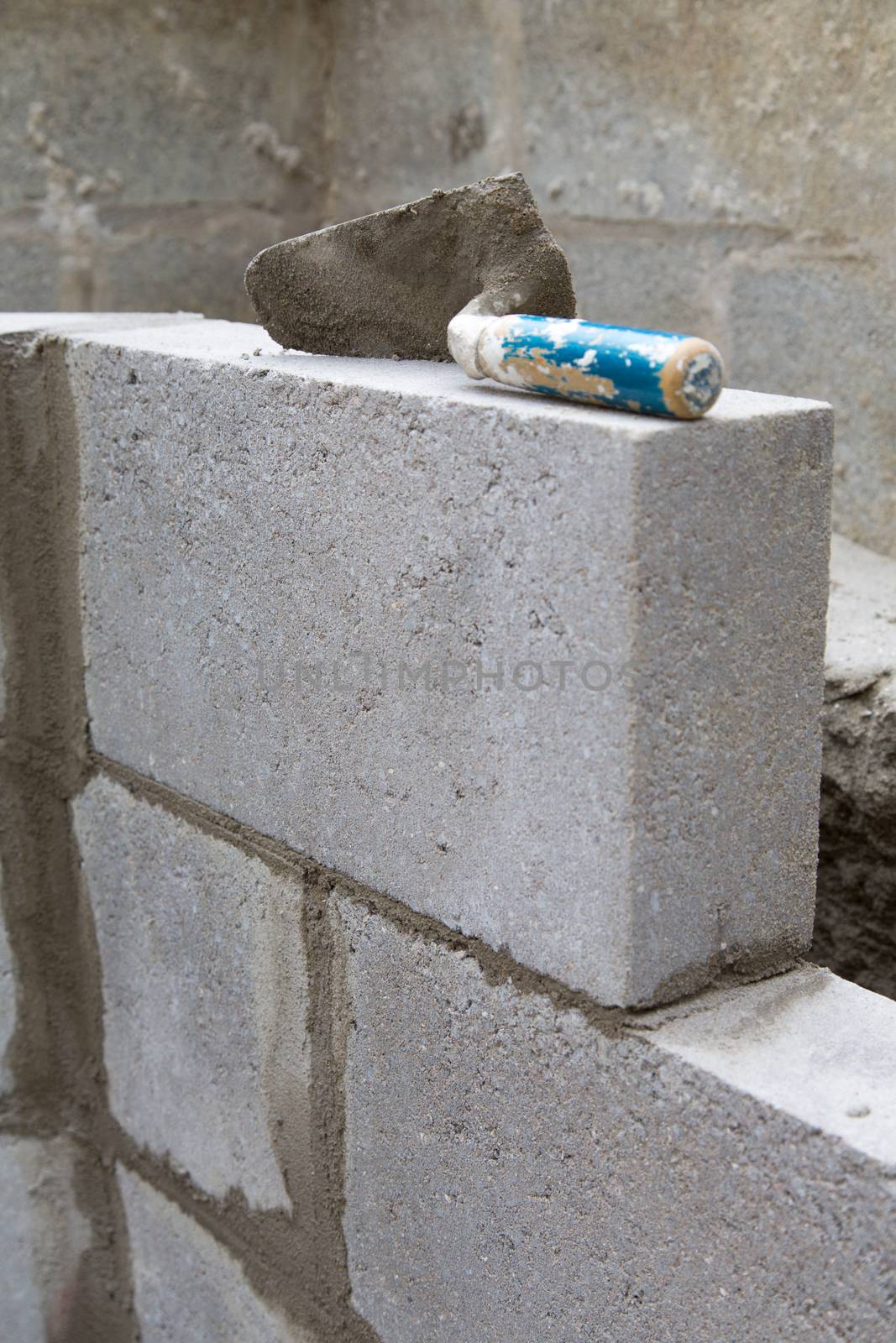 Empty trowel on a constructed wall outdoors