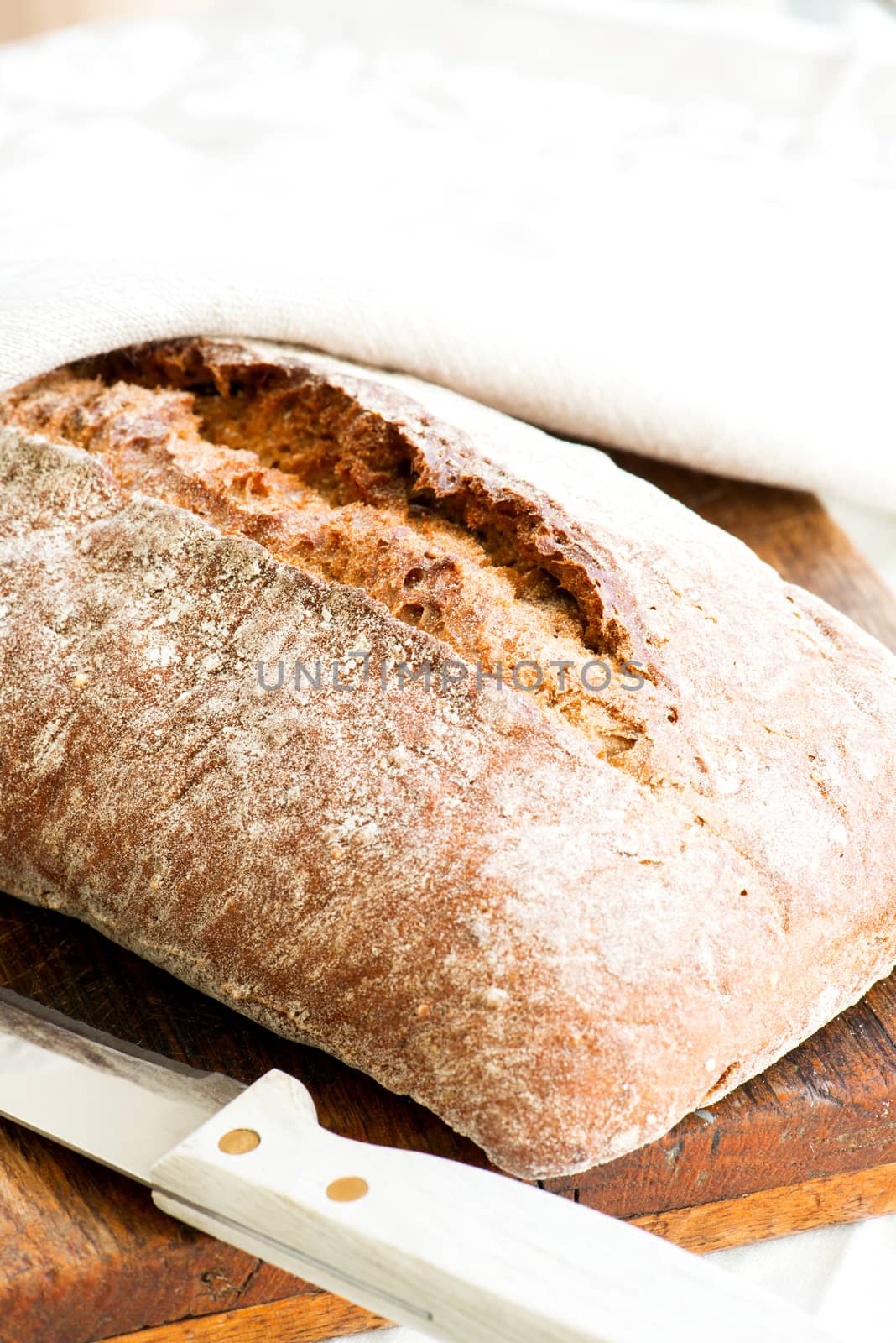 Close-up oven baked home made bread on cutting board