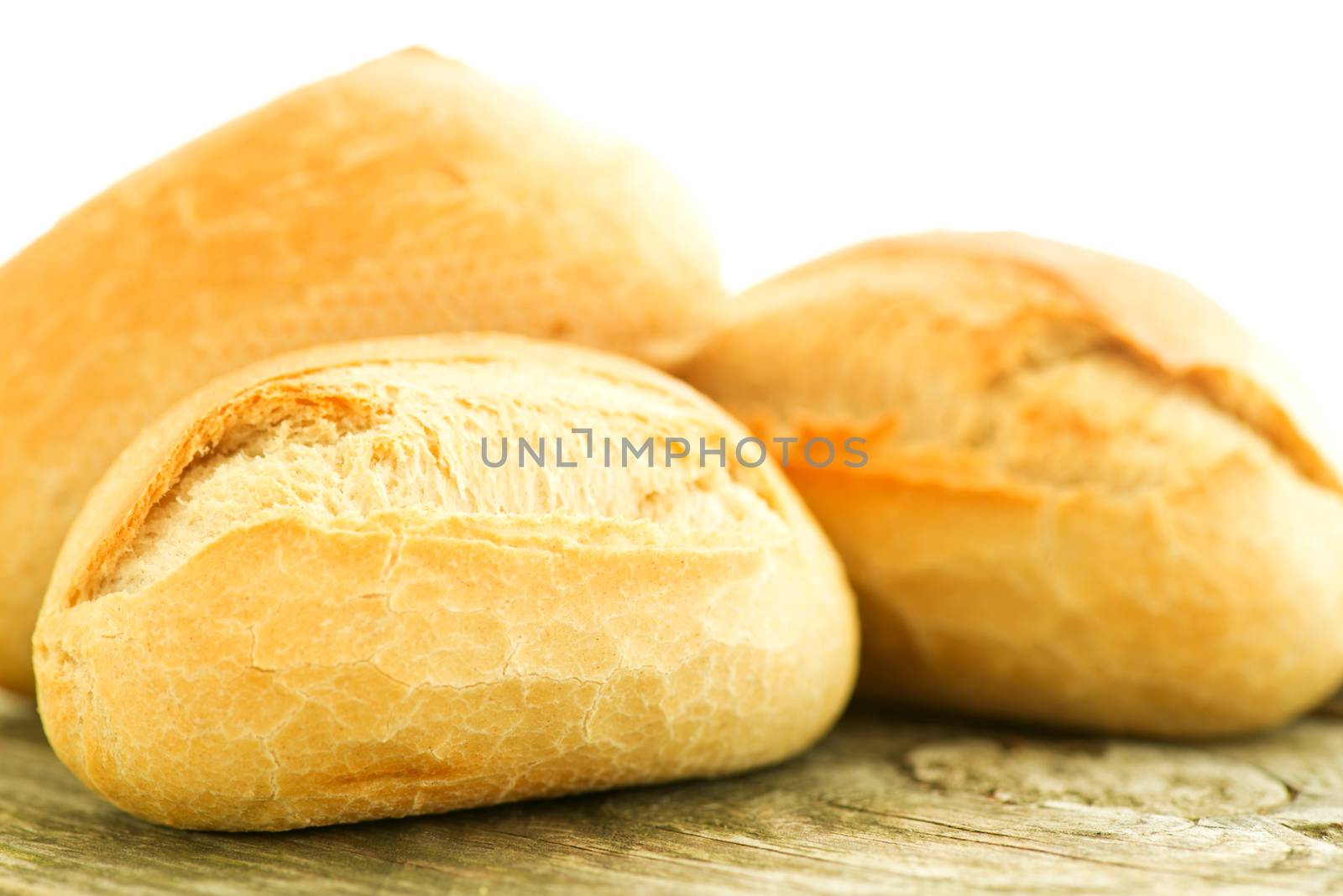 Bread on wooden table close up by Nanisimova