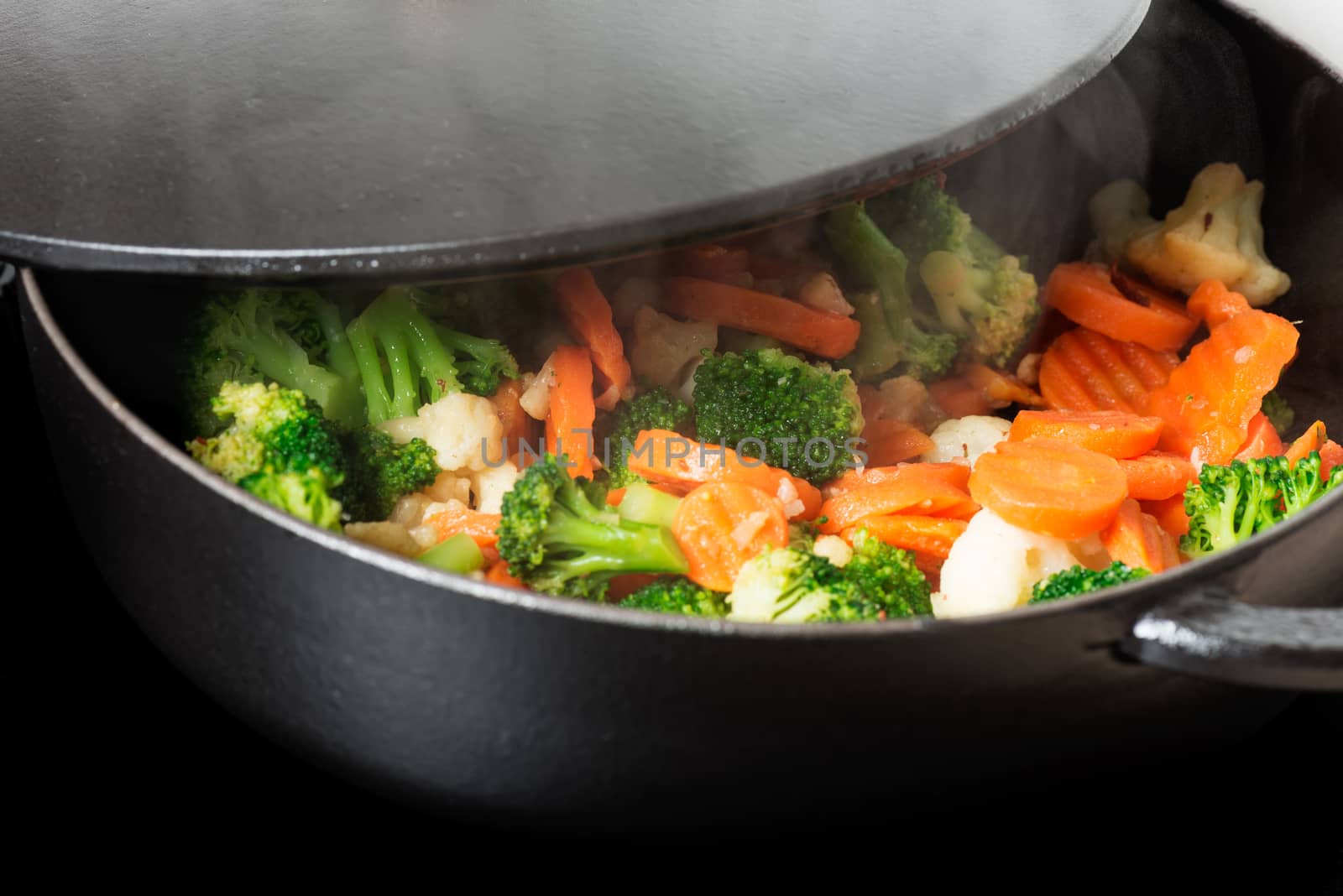 Frying frozen vegetables in fry pan, close up