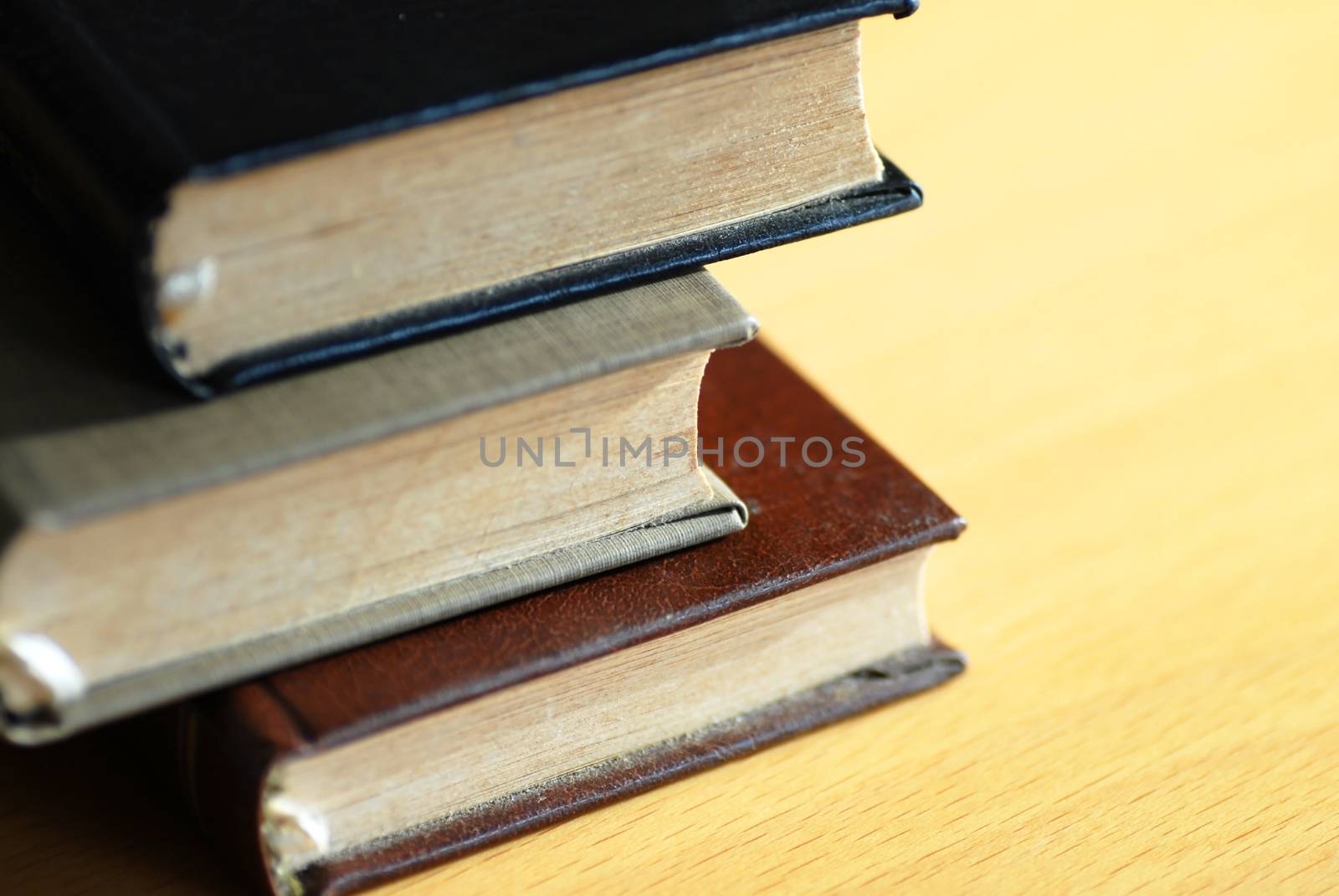 tree small books in pile on the desk