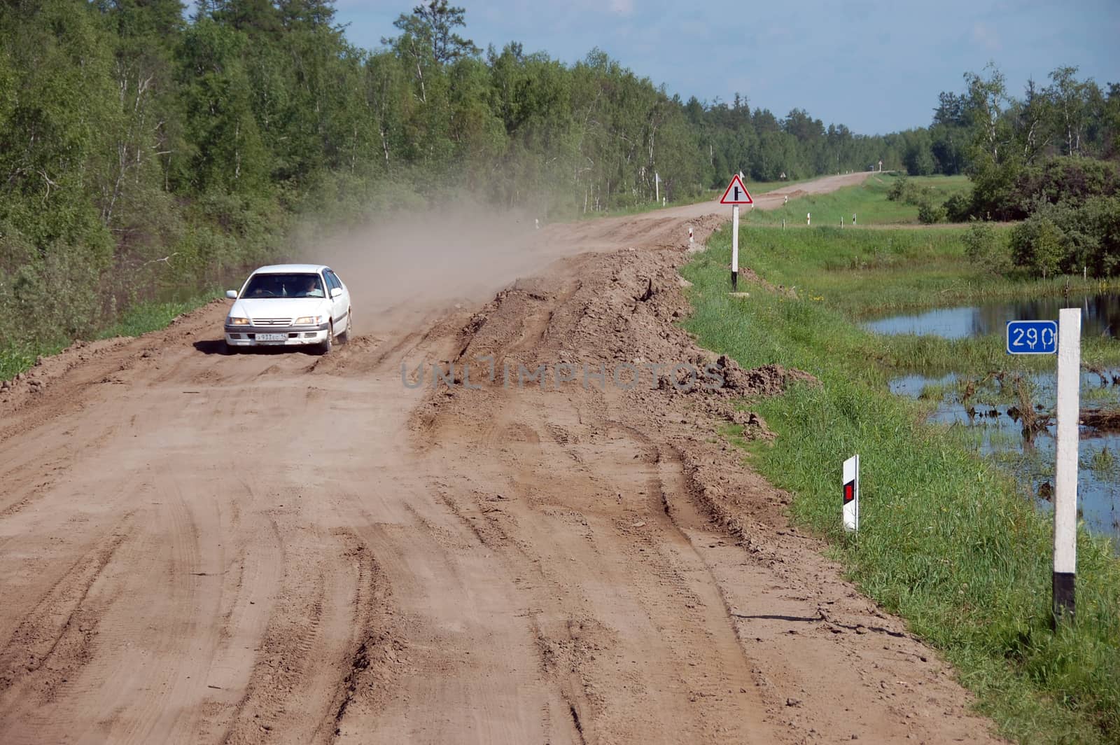 White car at gravel road Kolyma highway at Yakutia by danemo