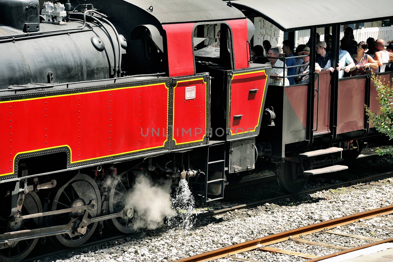 The steam locomotive tourist train from Anduze receding to hang cars and from Saint-Jean-du-Gard.