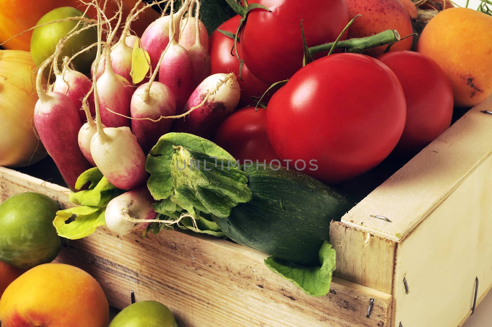 crates of fruit and vegetables on white background in studio. by gillespaire