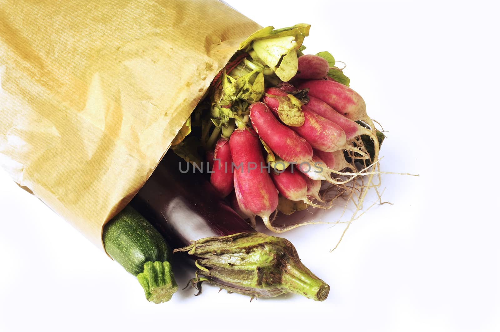 Vegetables in a bag of paper isolated on white background in studio
