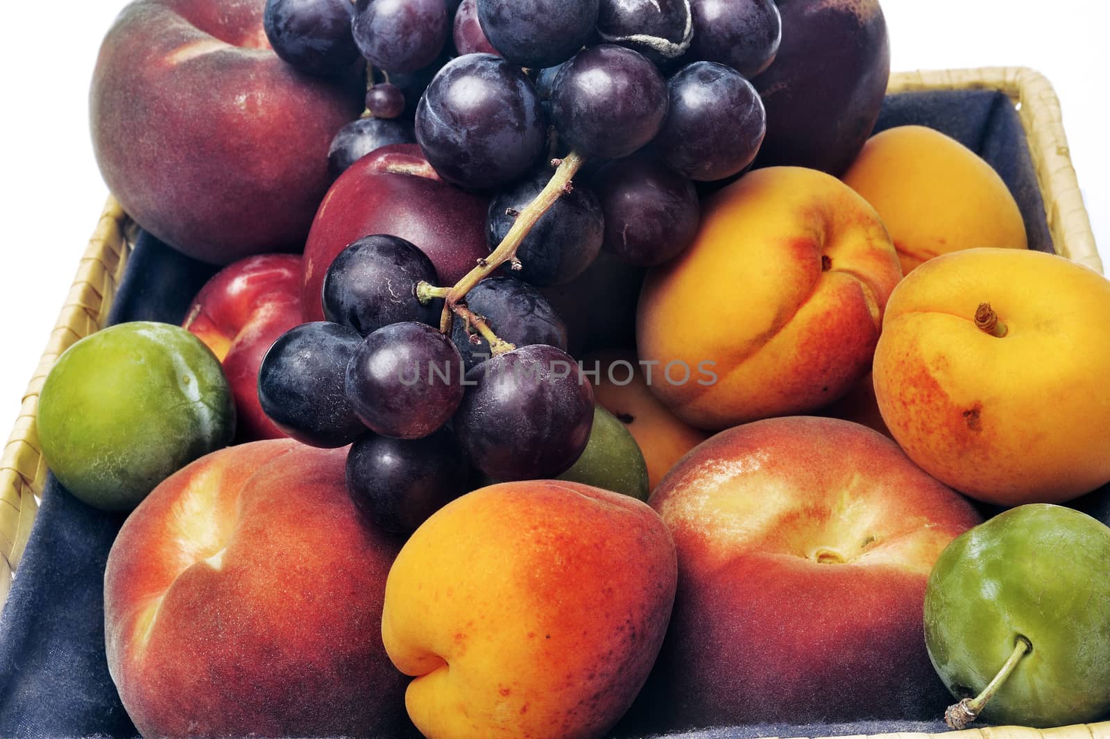 Basket of fruit isolated on white background in studio by gillespaire