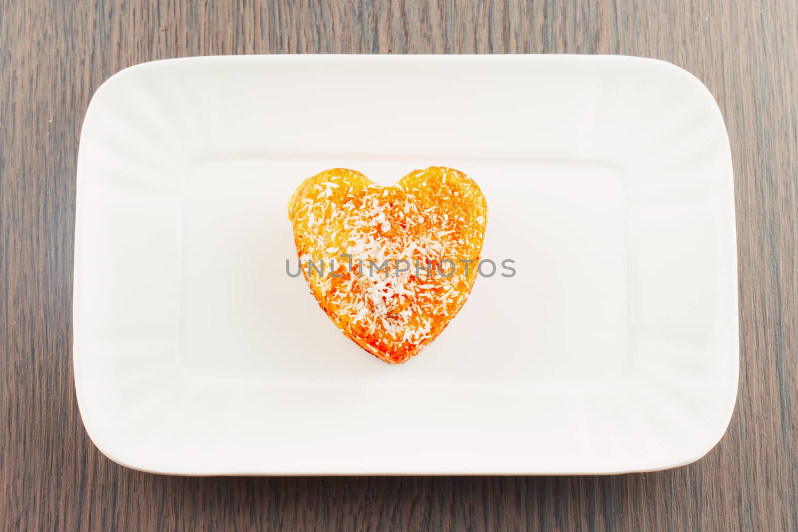 Biscuit in shape of heart over white plate