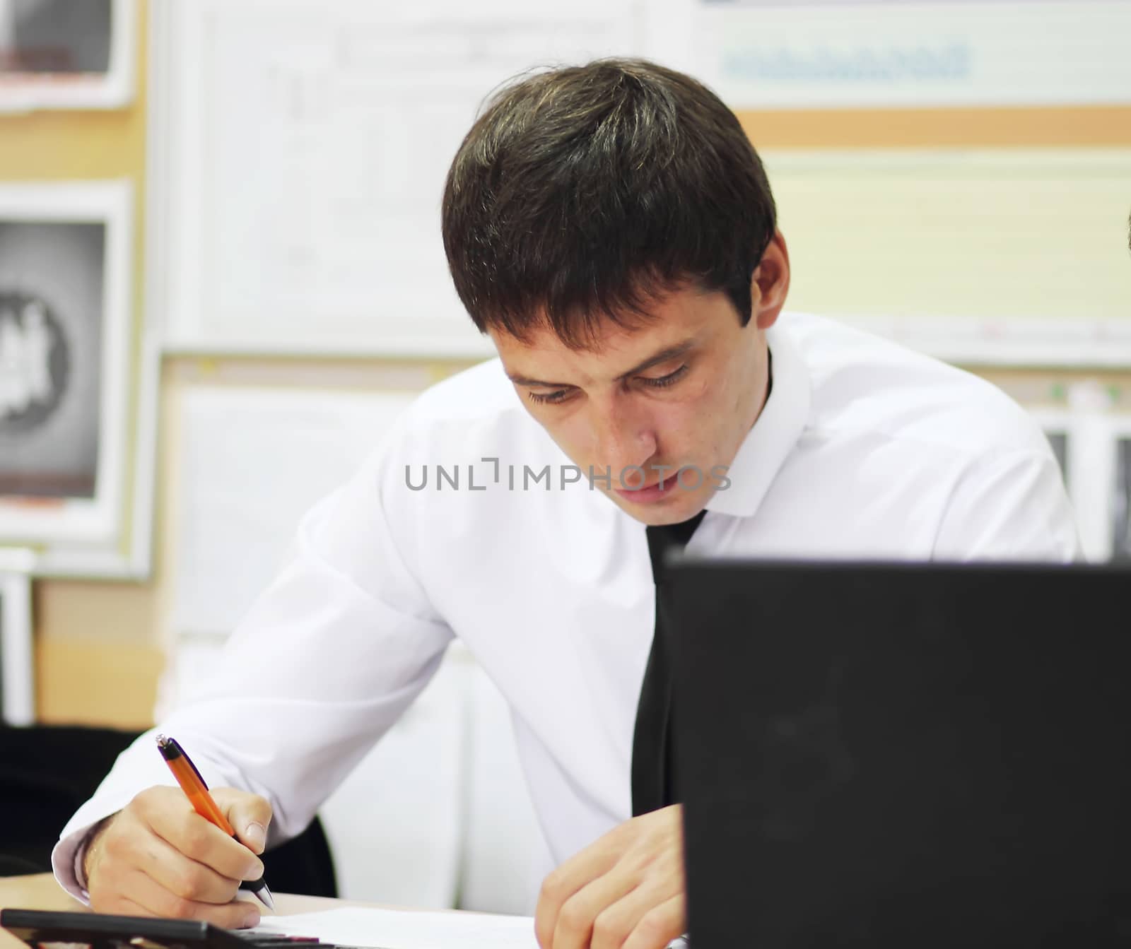 the manager in office working at a laptop