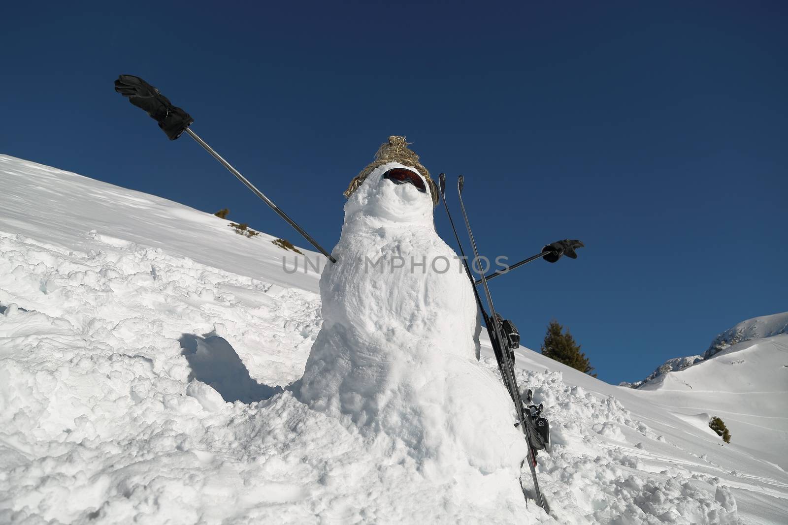 Snowman with skiis built on a slope