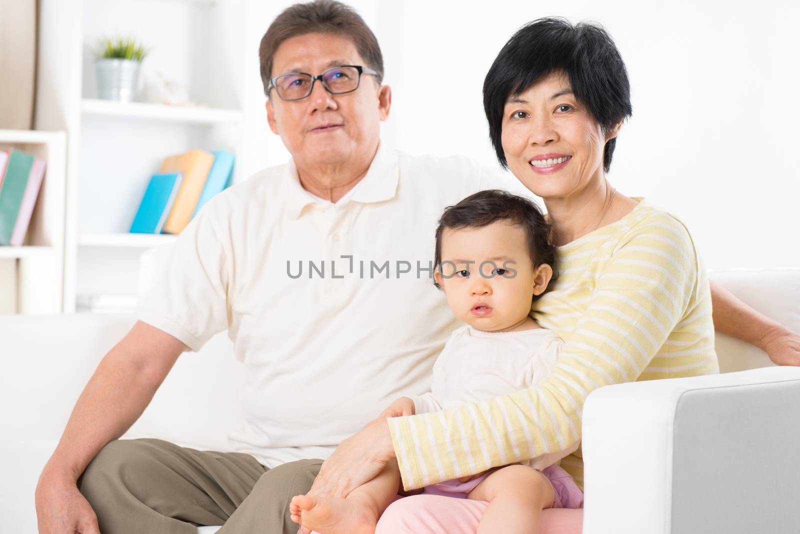 Asian family portrait, relaxing at home, grandparents and grandchild living lifestyle indoor.