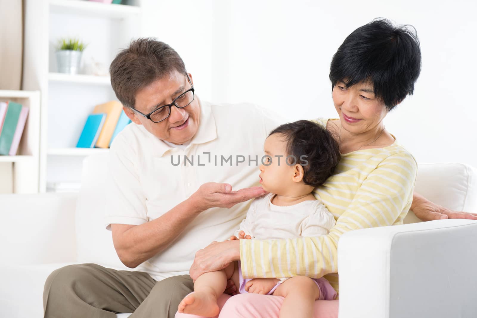 Asian family relaxing indoor, grandparents and grandchild living lifestyle at home.
