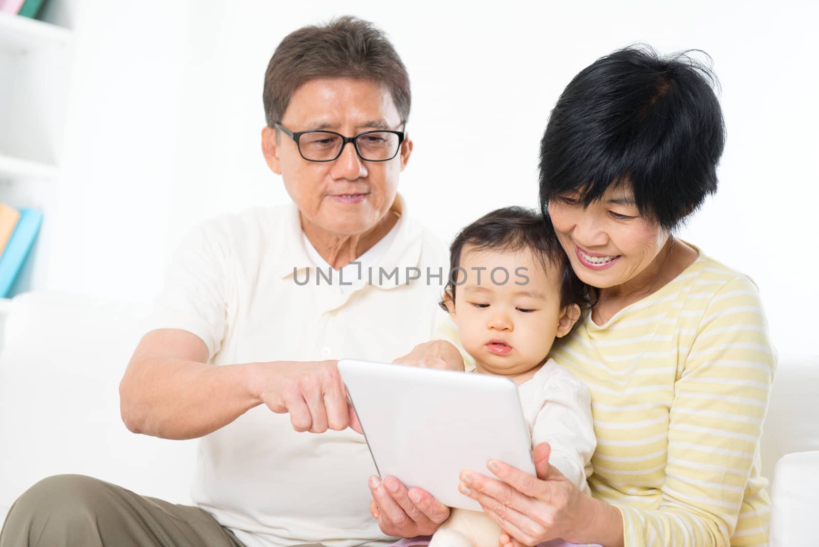 Asian family using tablet pc by szefei