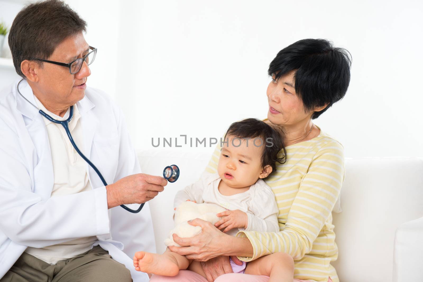 Family doctor examining baby girl. Pediatrician and patient.