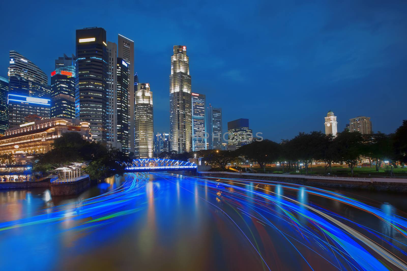 Singapore river cruise and skyscrapers at sunset