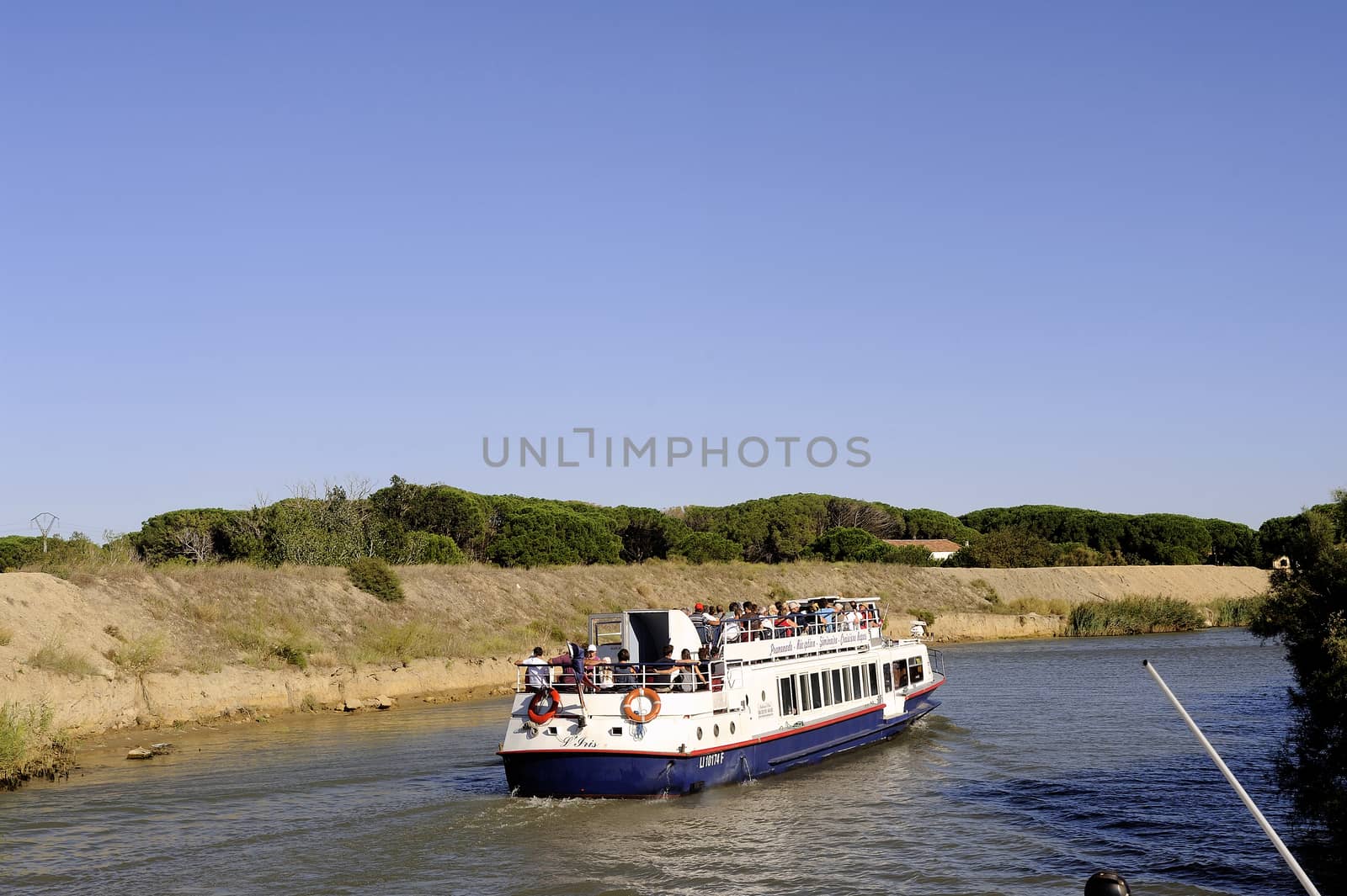 Sightseeing cruise on the Canal du Rhone in Aigues-Mortes in the heart of the Camargue in the south-east of France.