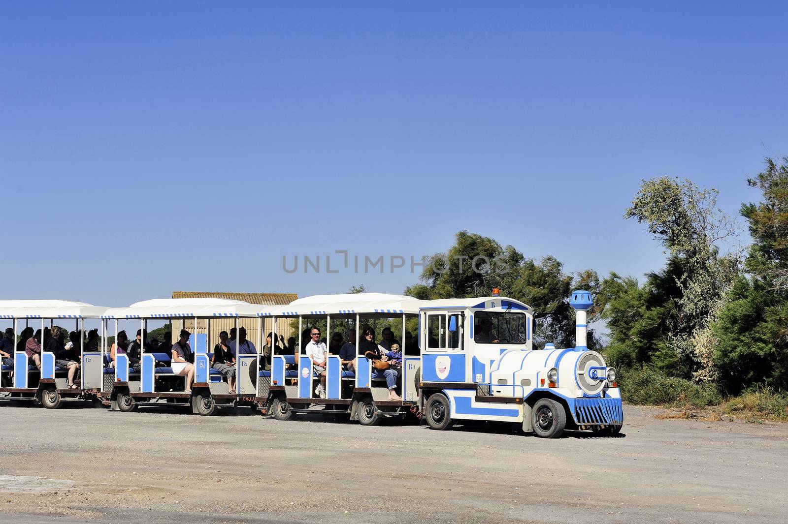 tourists in the tourist train to visit the salt business of Aigues-Mortes and to tour the mine salt site.