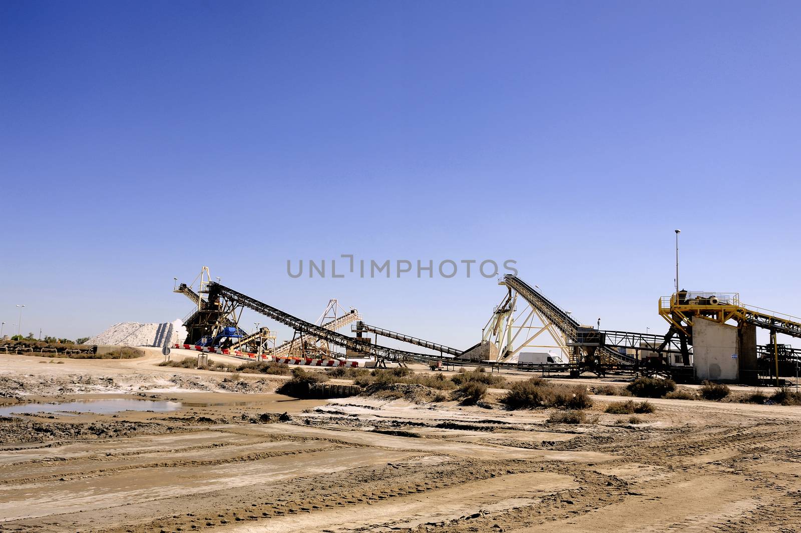 Site operating company saline Aigues-Mortes in the Camargue where stackers stack hills of sea salt.