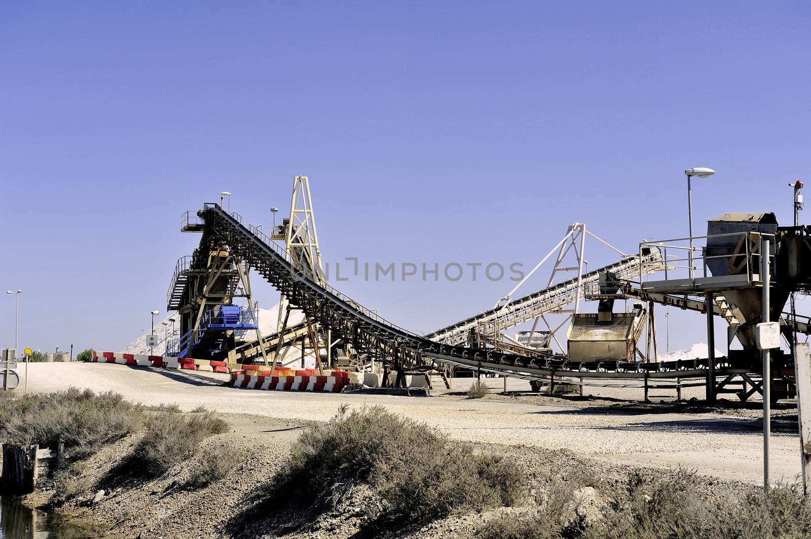 Site operating company saline Aigues-Mortes in the Camargue where stackers stack hills of sea salt.