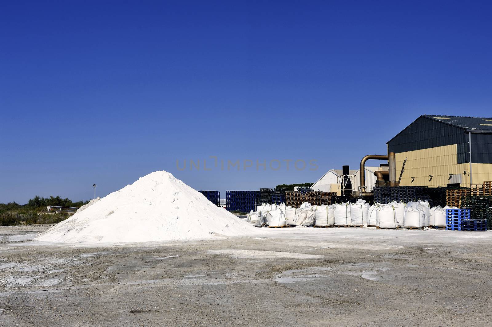 Site operating company saline Aigues-Mortes in the Camargue where stackers stack hills of sea salt.