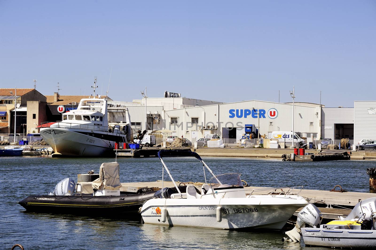 Small motor boat dock waiting to go out for a walk along the canal Le Grau-du-Roi in the Camargue