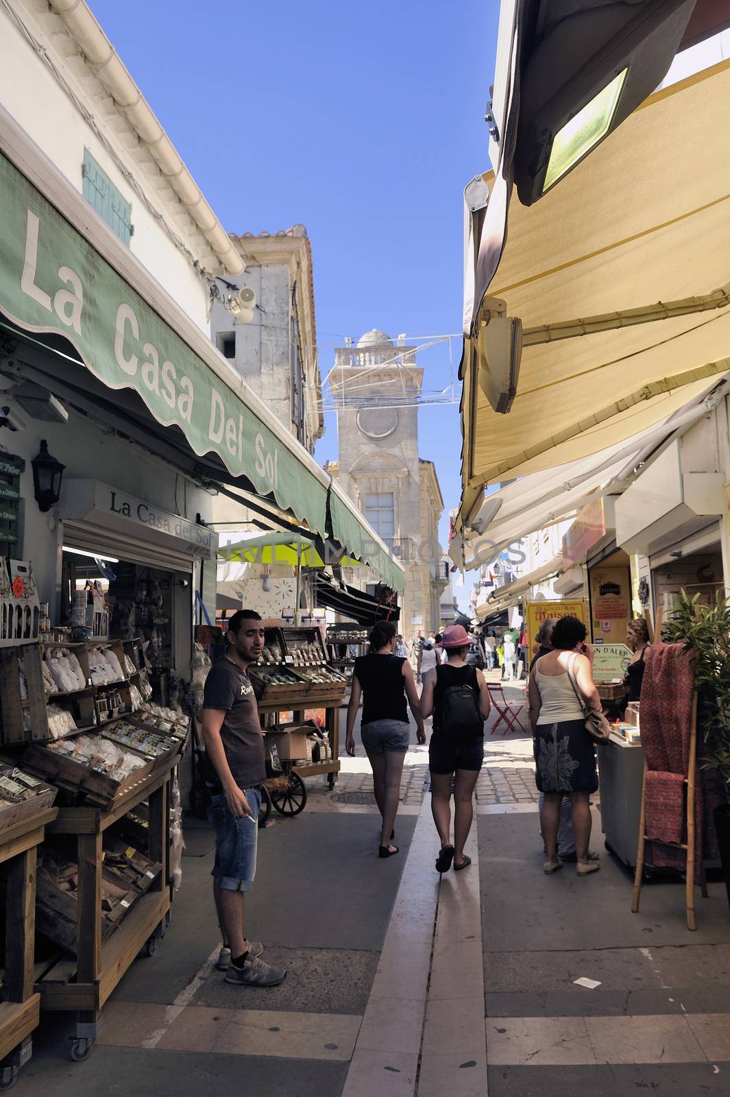 Walk through a pedestrian shopping street of Saintes-Maries-de-la-Mer in full summer.