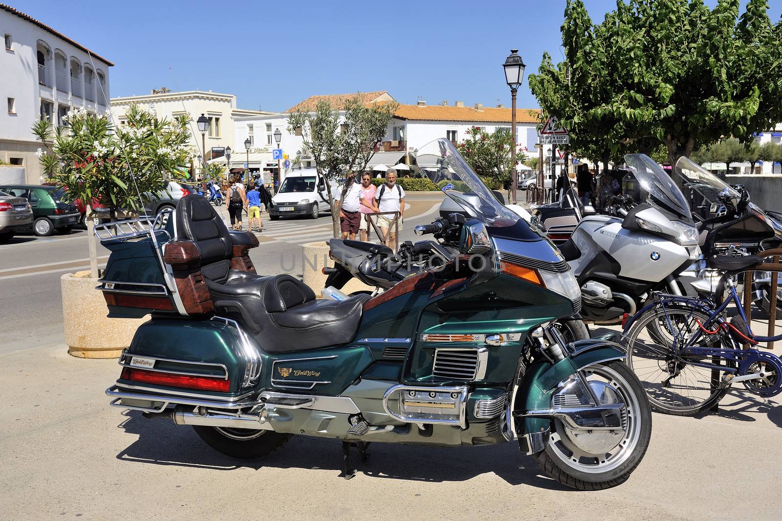 A nice bike Honda Goldwing parked downtown.