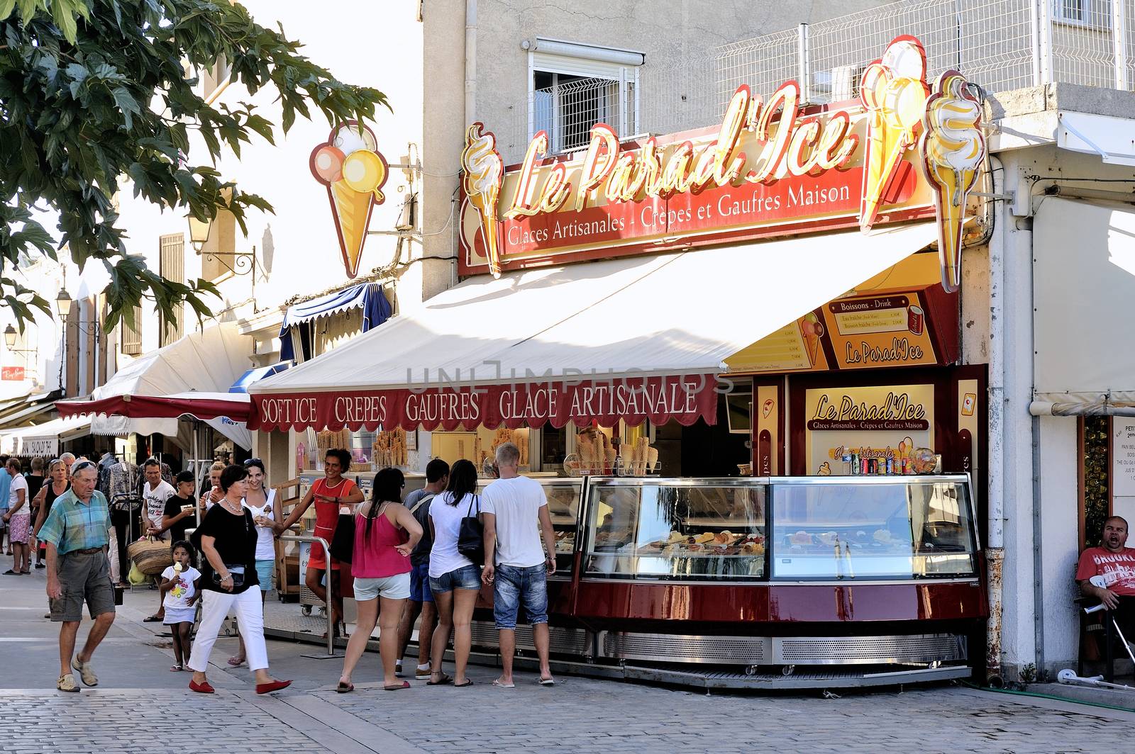 Ice cream shop in the pedestrian street of Saintes-Maries-de-la- by gillespaire