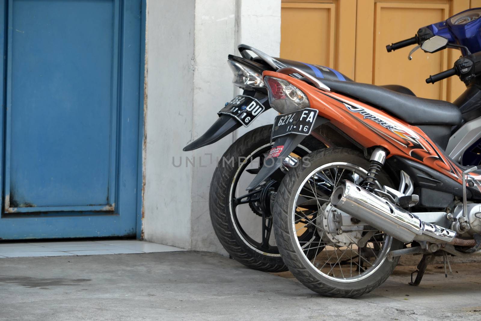 Bandung, Indonesia - September 18, 2014: Various type of motorcycle get parked beside office garage.