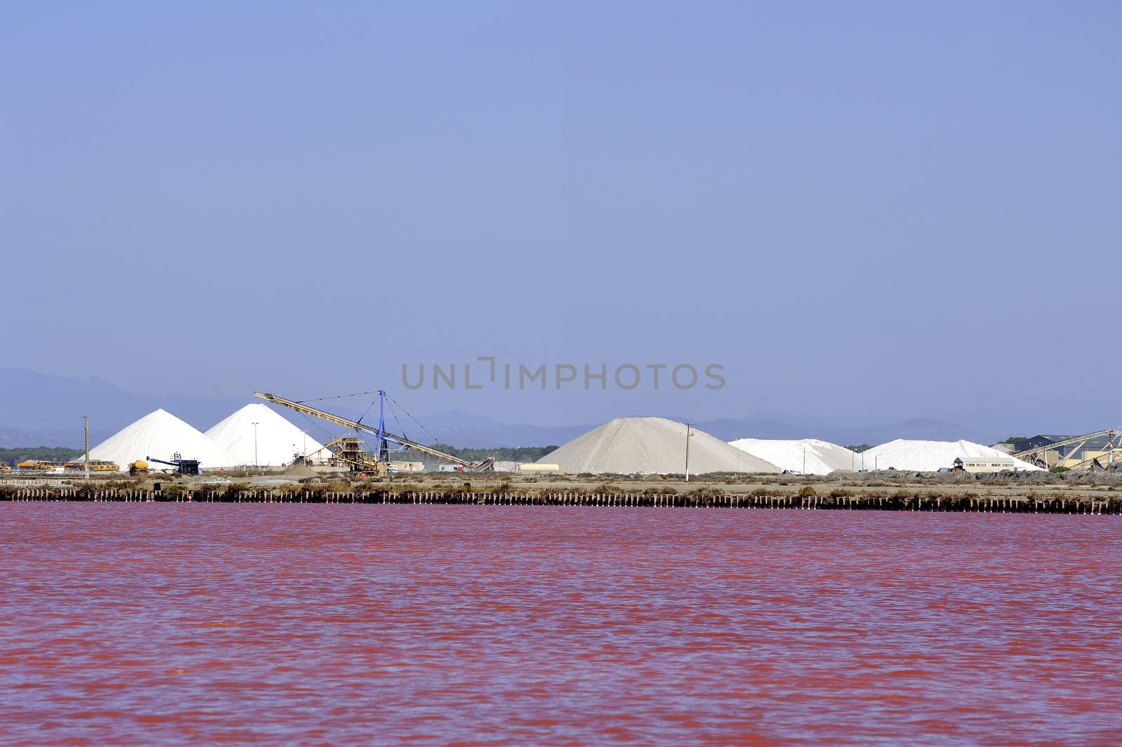 Site operating sea salt saline Aigues-Mortes in the season when a pink algae grow in the water, which gives this beautiful color.