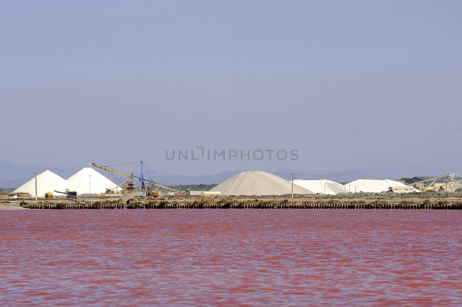 Site operating sea salt saline Aigues-Mortes in the season when a pink algae grow in the water, which gives this beautiful color.