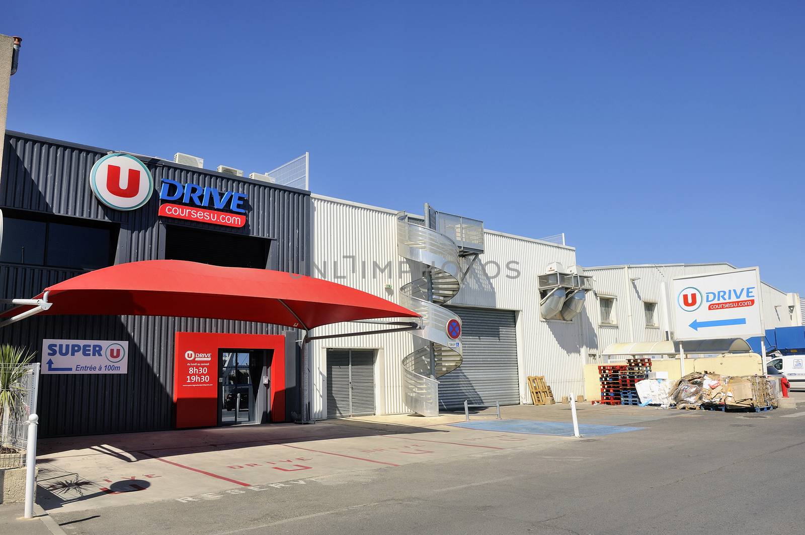 Drive to French supermarket delivery point to pick orders placed with Internet