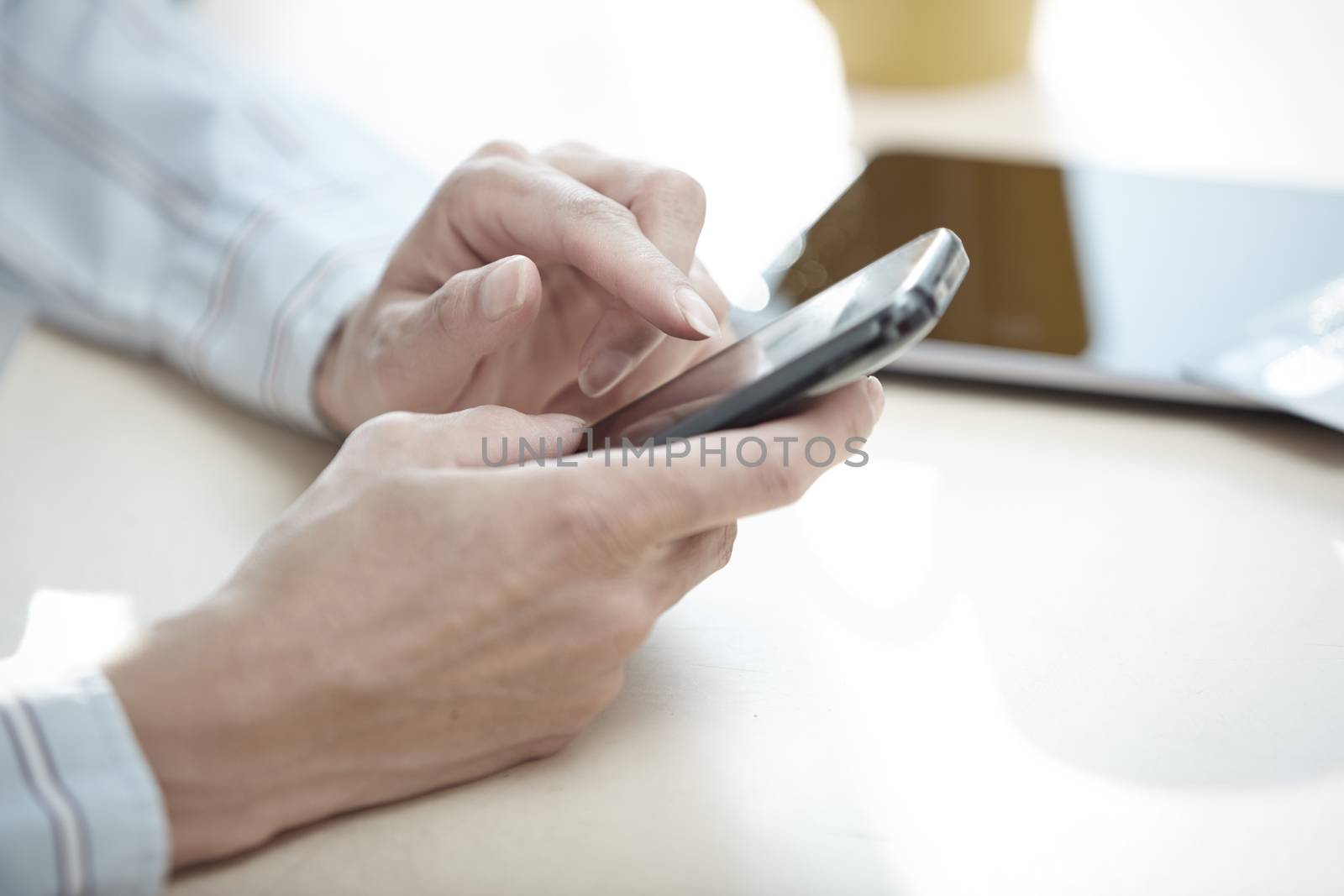 Hands of smartphone user at lunch