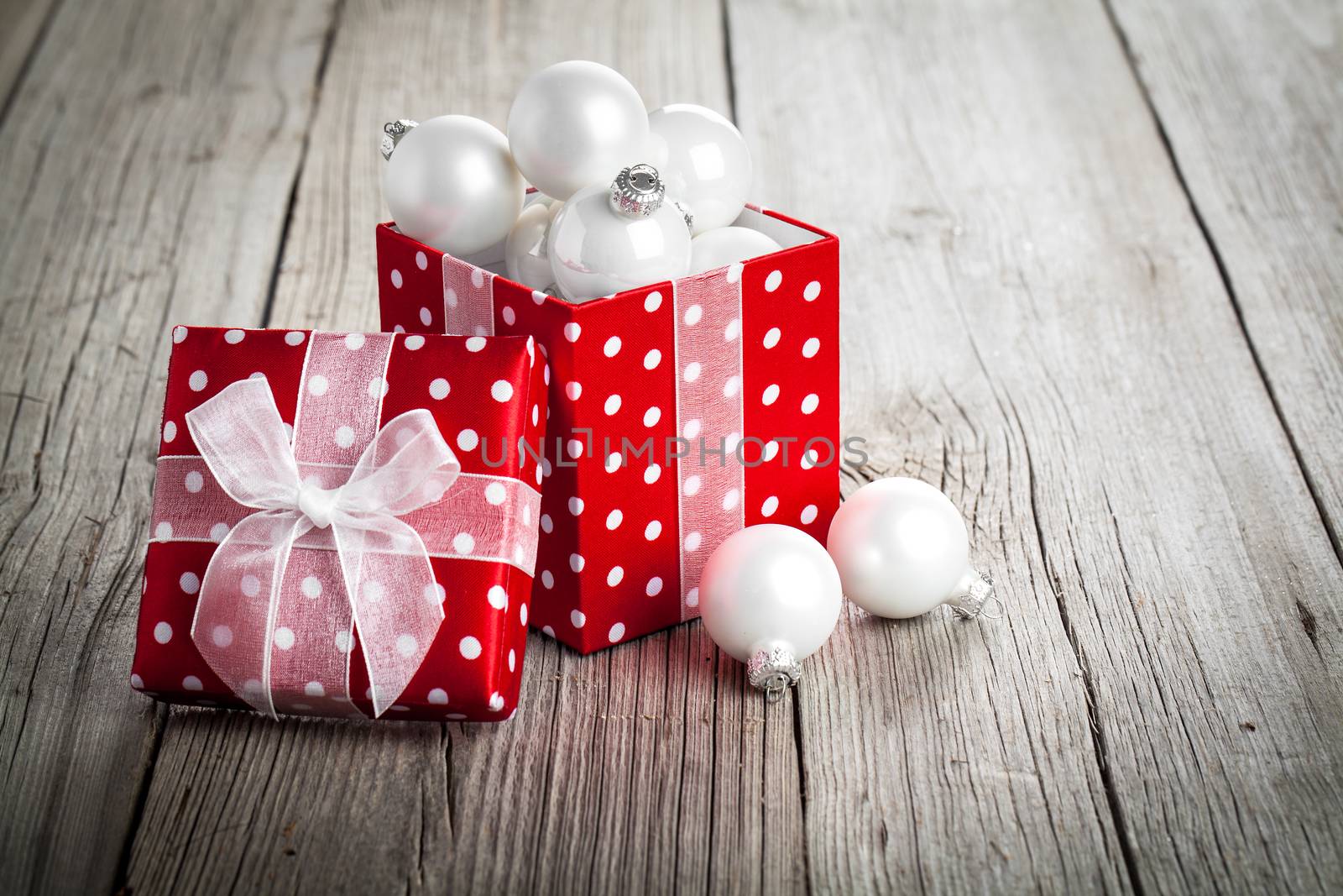red Christmas gift box, polka dots, on wood background