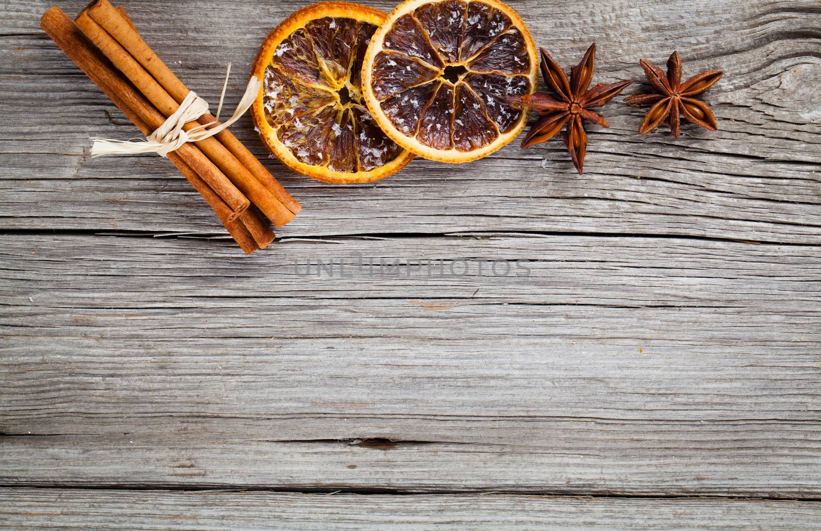 dry orange, cinnamon and Star Anise with copy space, on wooden background