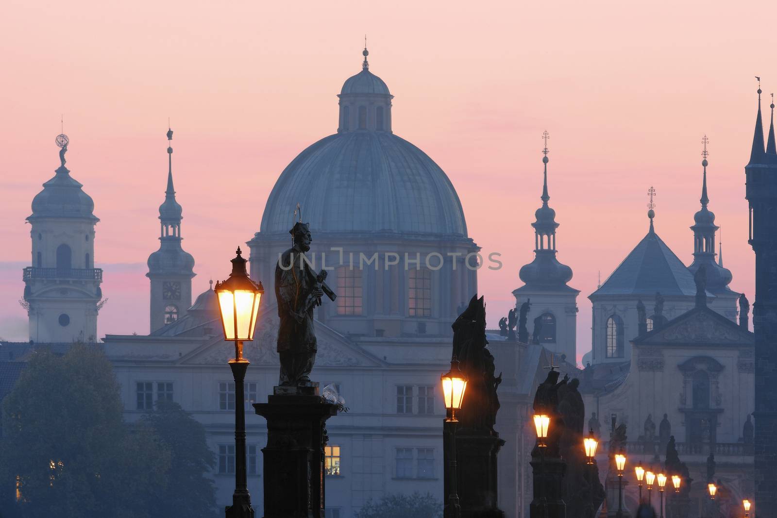prague - charles bridge and spires of the old town at dawn