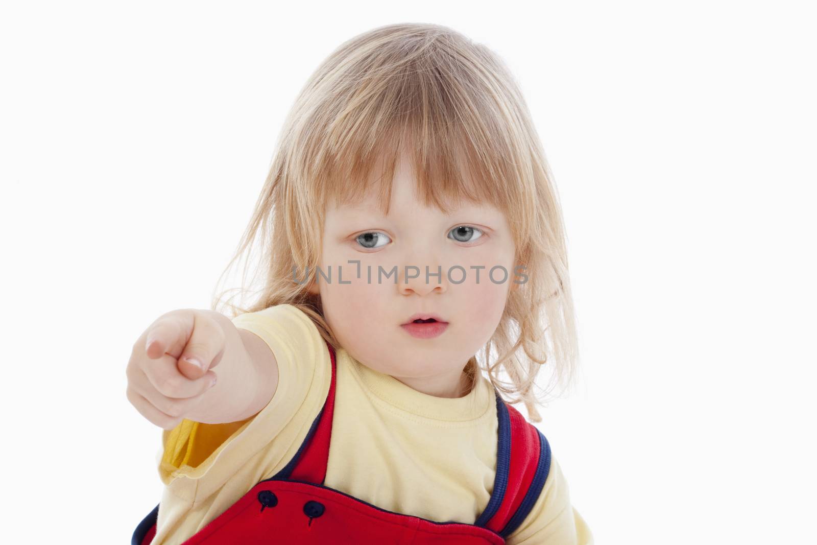 portrait of a boy with long blond hair pointing his finger